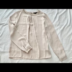 Blouse with beaded neck